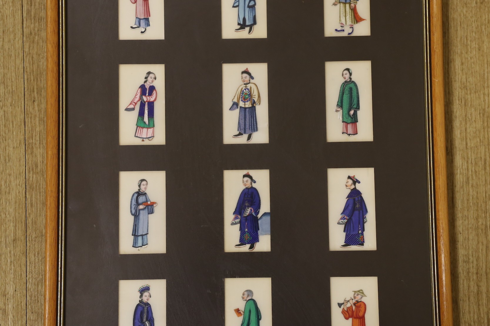 19th century Chinese School, seventeen gouaches on pith paper, Figure studies, 9 x 4.5cm, framed as one